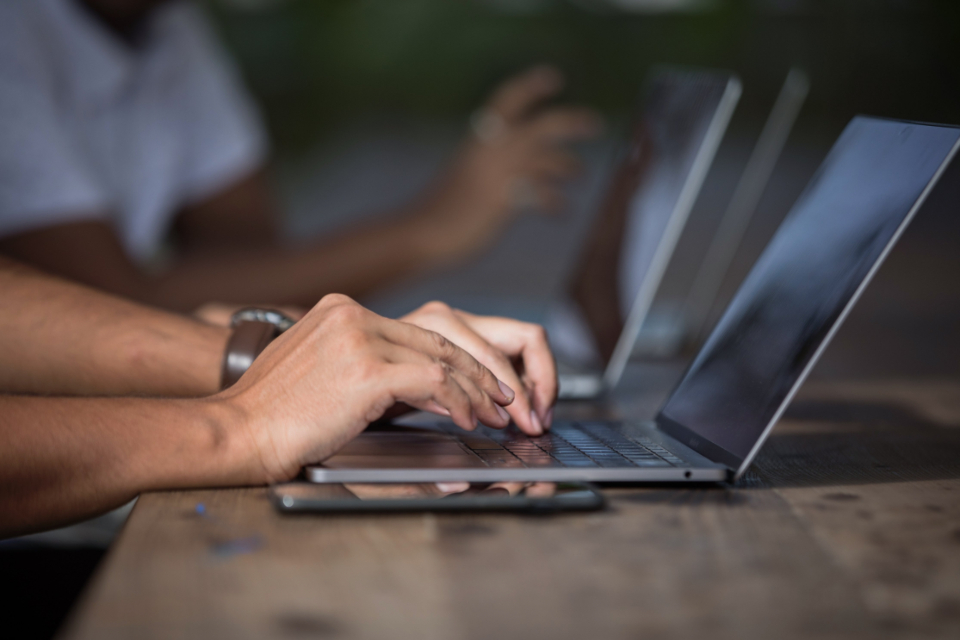 Person working on laptop representing workflow automation